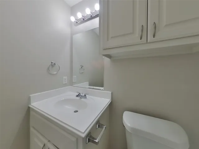 a bathroom with a sink a toilet and mirror
