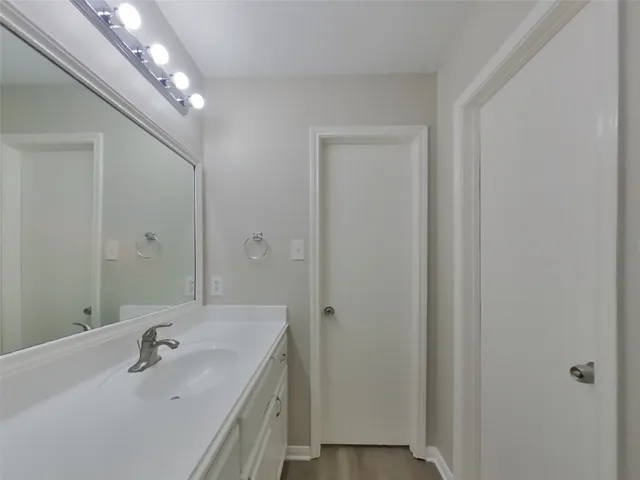 a bathroom with a sink a large mirror and shower