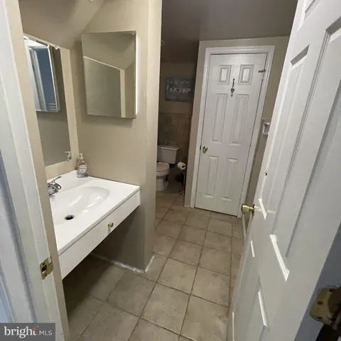 a bedroom with a bed and dresser with the mirror