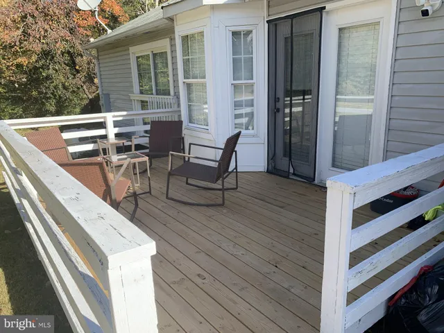 a view of a patio with table and chairs couches under an umbrella