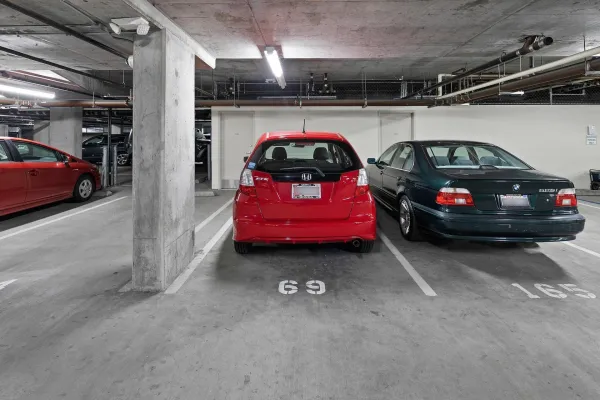 a view of parking garage with cars parked