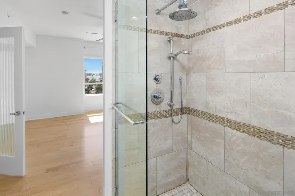 a bathroom with a glass shower door