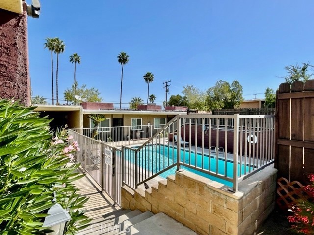 68460 Kings Road, Unit C Cathedral City, CA 92234 - Photo 2 of 18 a view of a house with wooden deck and furniture