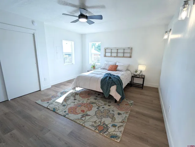 a bedroom with a bed and wooden floor
