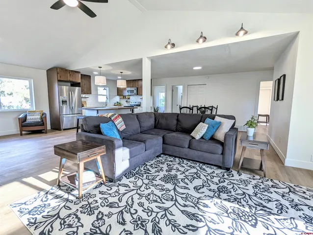 a living room with furniture and a wooden floor