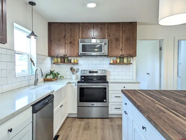 a kitchen with a stove a sink and a microwave