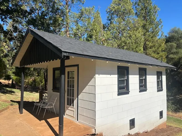 a view of house with backyard
