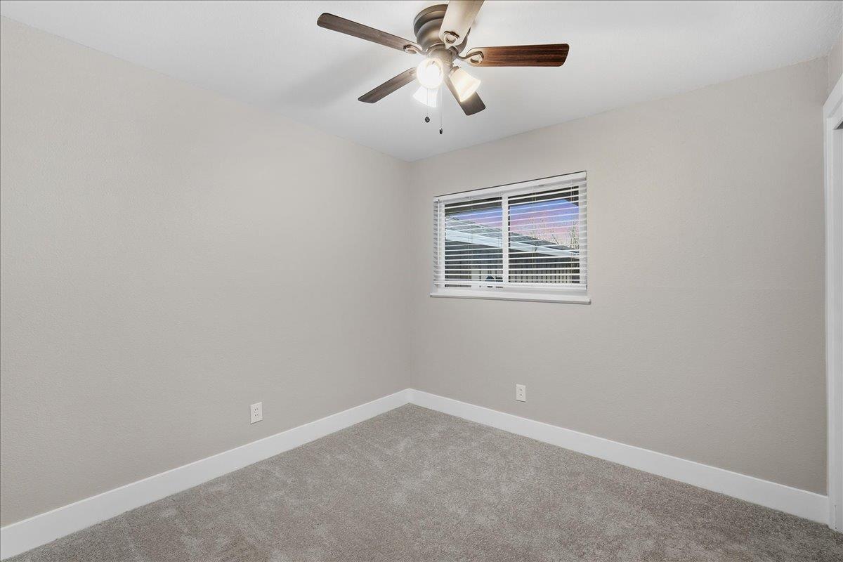 312 D Street Lincoln, CA 95648 - Photo 19 of 51 an empty room with chandelier fan and windows