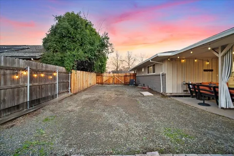a view of a fountain in front of house with a yard