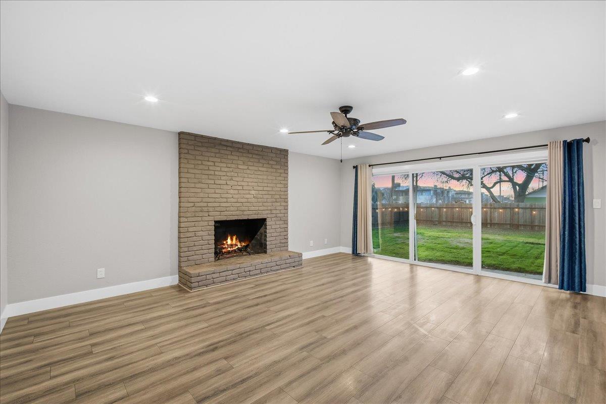 312 D Street Lincoln, CA 95648 - Photo 5 of 51 a view of an empty room with wooden floor fireplace and a window