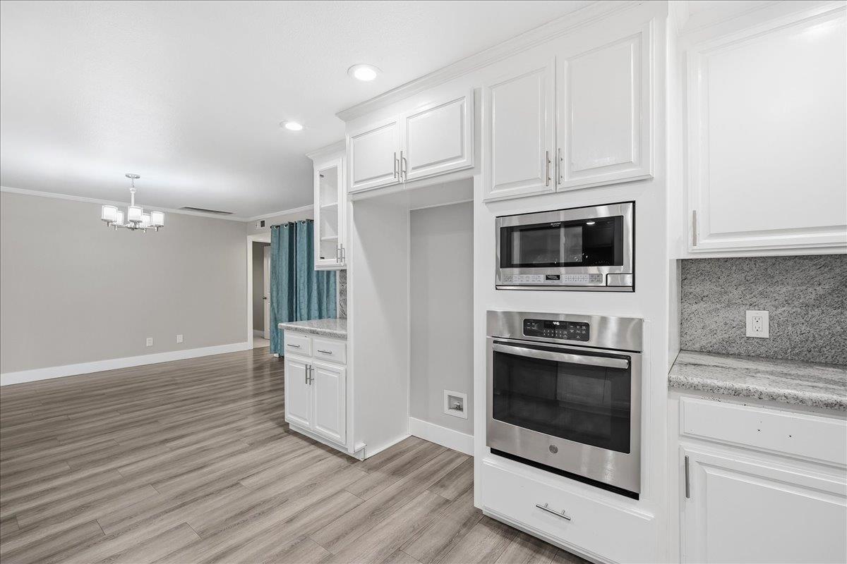 312 D Street Lincoln, CA 95648 - Photo 8 of 51 a kitchen with white cabinets and stainless steel appliances
