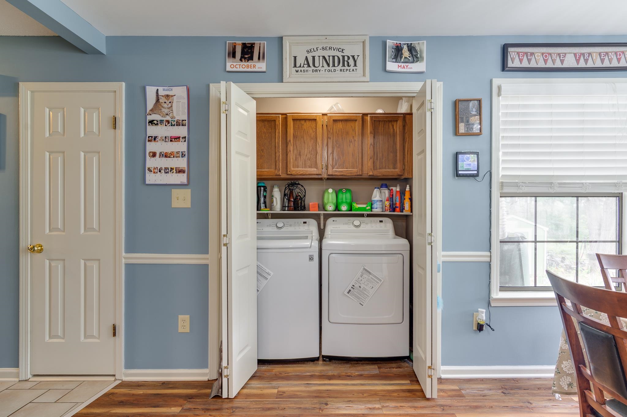4099 Soderlund Cove Millington, TN 38053 - Photo 10 of 26 Laundry area featuring washer and clothes dryer, light wood-style flooring, and cabinet space
