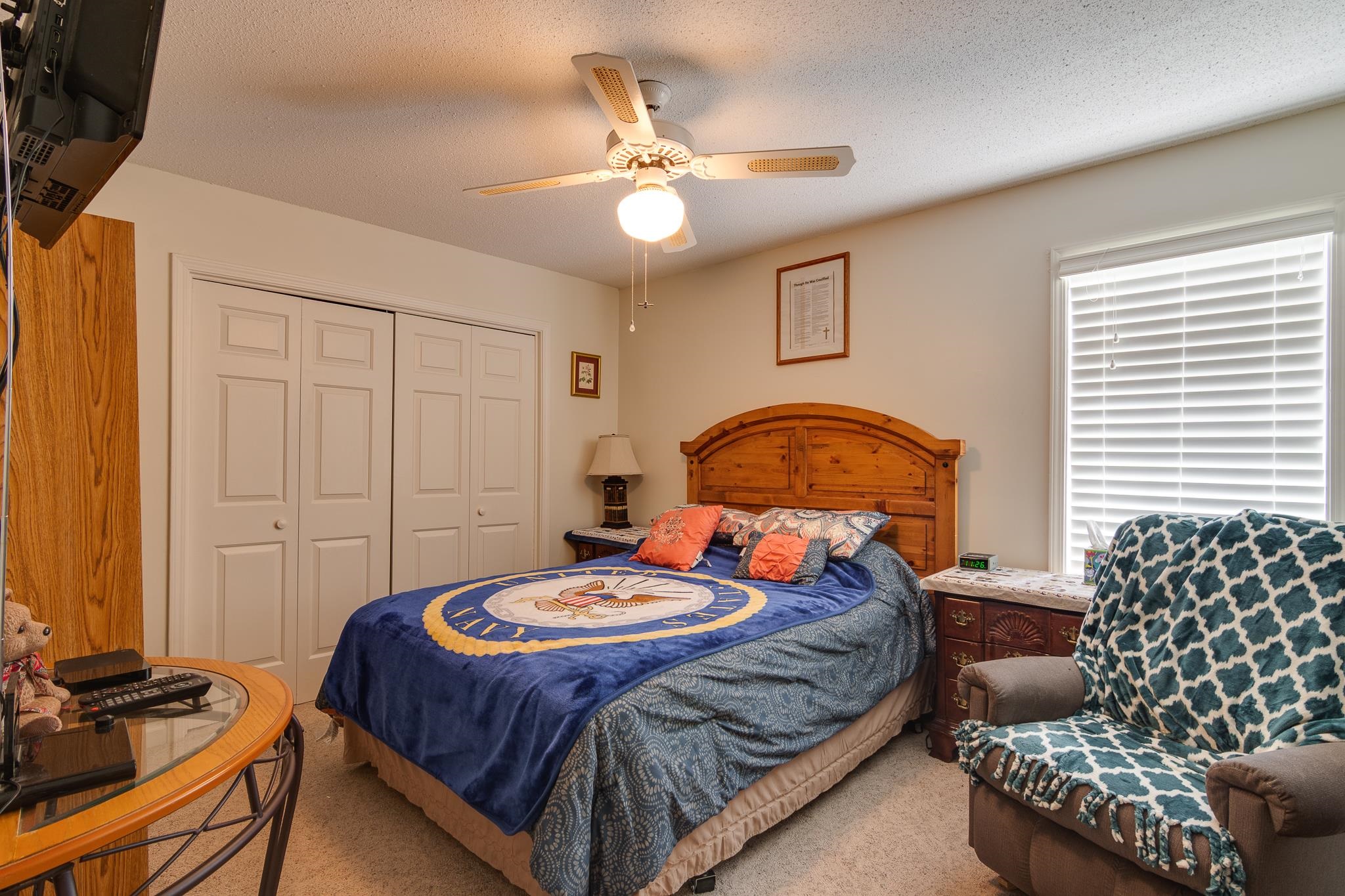 4099 Soderlund Cove Millington, TN 38053 - Photo 19 of 26 Bedroom featuring carpet, a textured ceiling, a closet, and ceiling fan