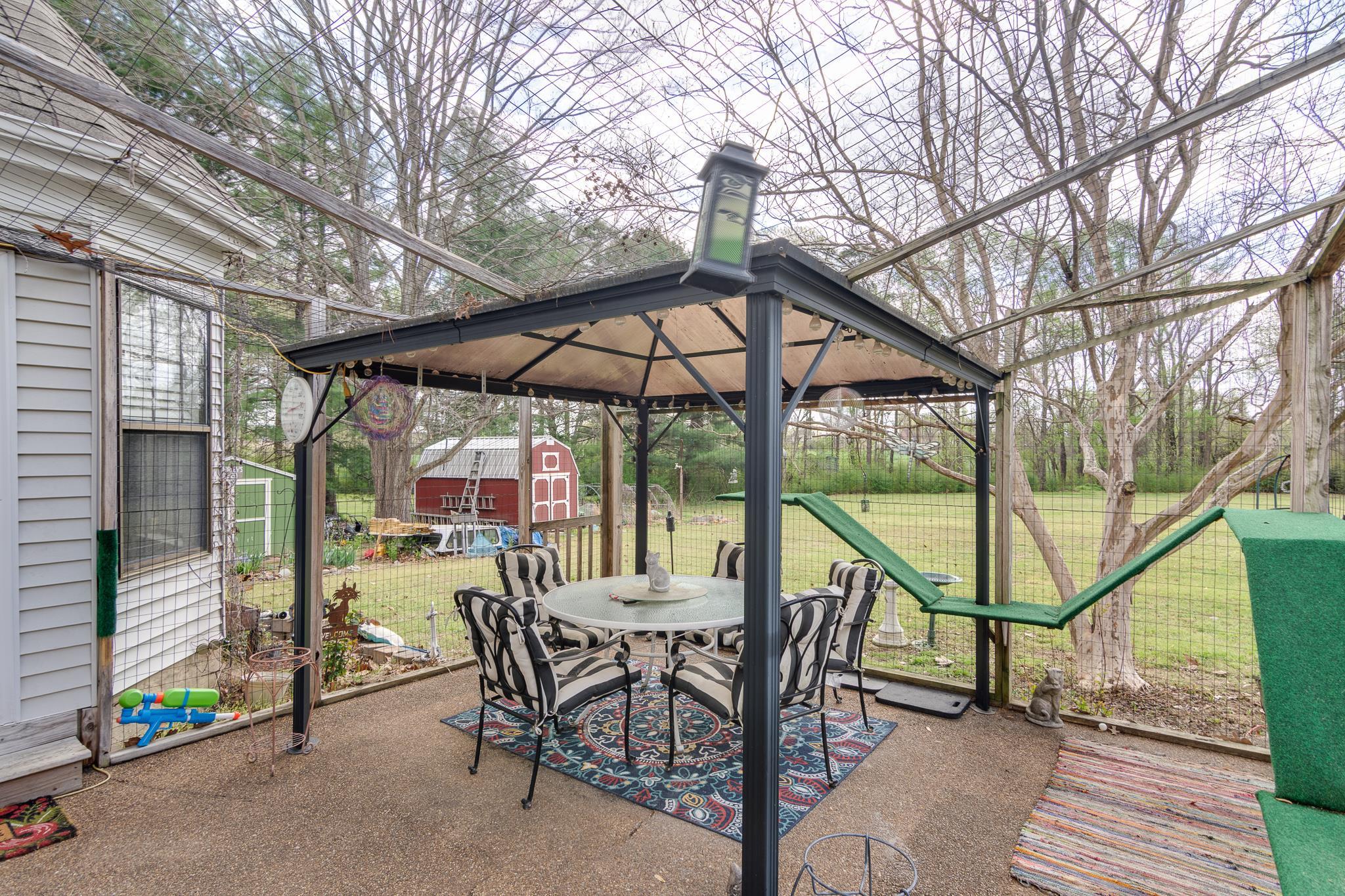 4099 Soderlund Cove Millington, TN 38053 - Photo 20 of 26 View of patio / terrace featuring outdoor dining space, a gazebo, and a storage shed