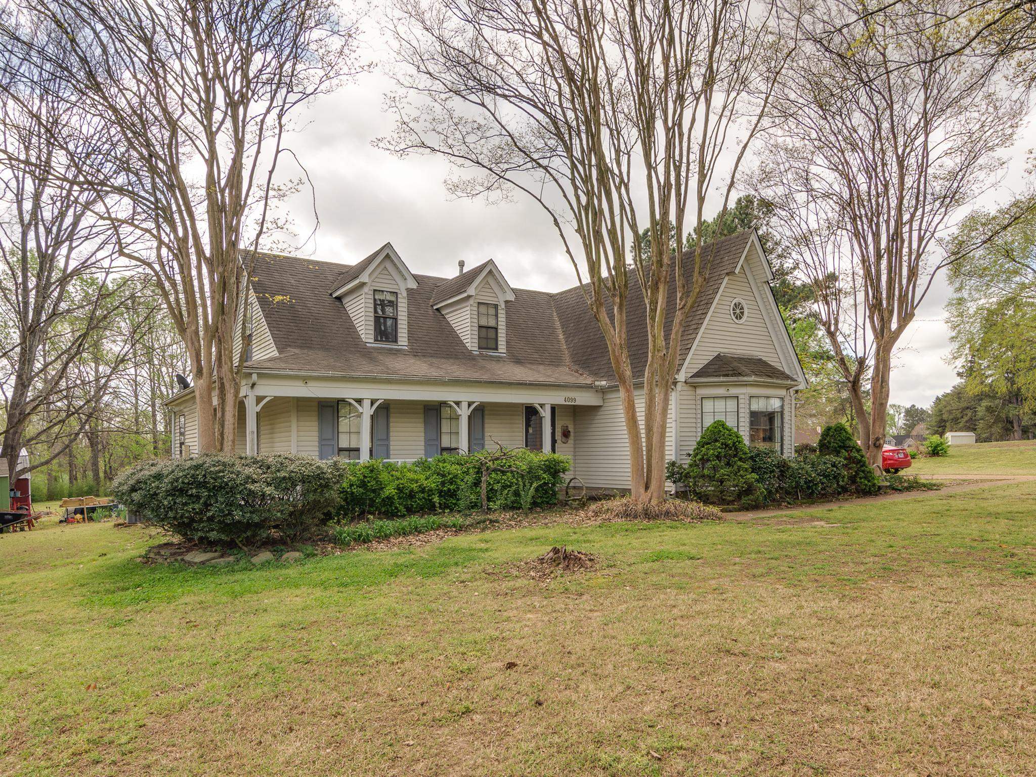 4099 Soderlund Cove Millington, TN 38053 - Photo 24 of 26 New england style home with covered porch, a front lawn, and roof with shingles