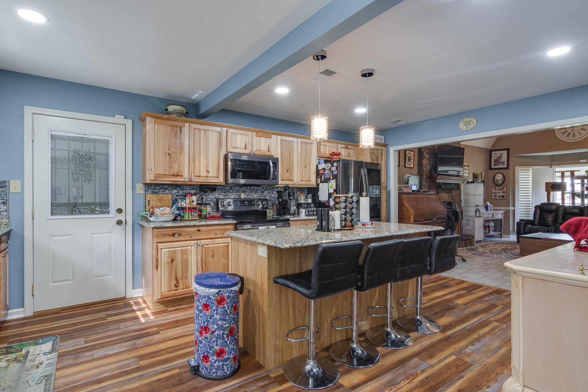 4099 Soderlund Cove Millington, TN 38053 - Photo 25 of 26 Kitchen with open floor plan, a kitchen breakfast bar, pendant lighting, a kitchen island, and stainless steel appliances