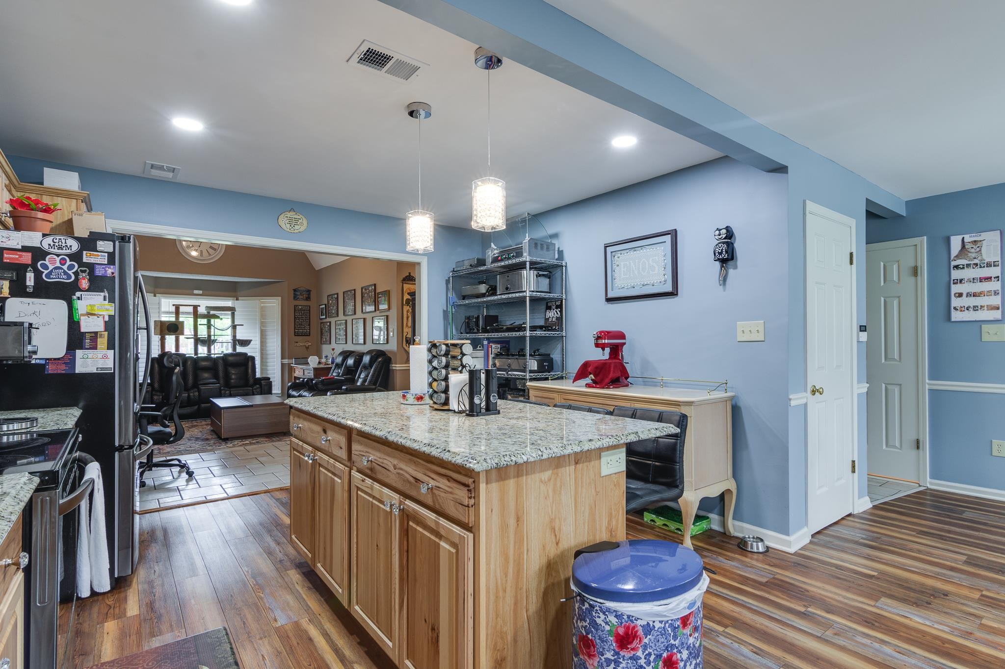 4099 Soderlund Cove Millington, TN 38053 - Photo 26 of 26 Kitchen featuring light stone countertops, a kitchen island, range with electric stovetop, open floor plan, and dark wood finished floors