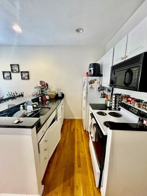 17 Thacher Street, Unit 3 Boston, MA 02113 - Photo 10 of 24 a kitchen with a sink a stove and cabinets