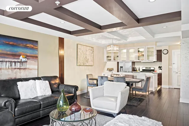 a living room with furniture wooden floor and kitchen view