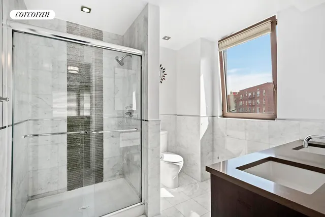 a bathroom with a shower sink and toilet