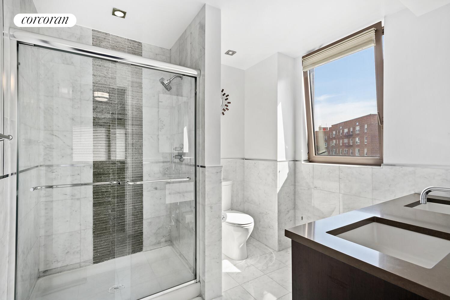 64-05 Yellowstone Boulevard, Unit 405A Queens, NY 11375 - Photo 6 of 7 a bathroom with a shower sink and toilet