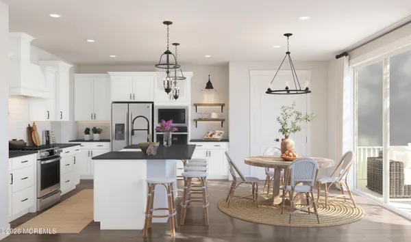 a view of a dining room and livingroom with furniture kitchen and chandelier