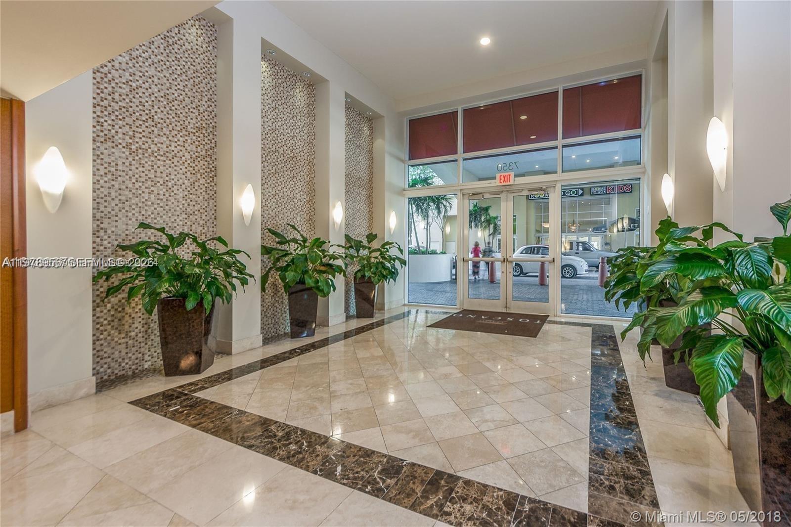 7350 Southwest 89th Street, Unit 719S Miami, FL 33156 - Photo 2 of 3 a view of a lobby with chair and tables