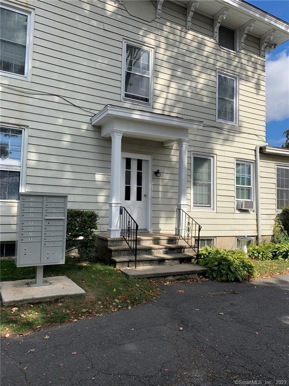 198 Flax Hill Road, Unit 3 Norwalk, CT 06854 - Photo 2 of 12 a front view of a house with a yard