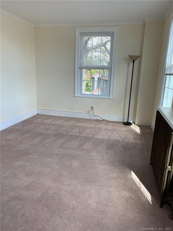 198 Flax Hill Road, Unit 3 Norwalk, CT 06854 - Photo 4 of 12 an empty room with windows