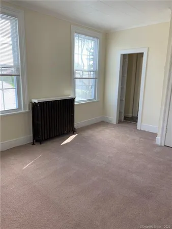 an empty room with windows and closet