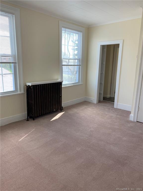 198 Flax Hill Road, Unit 3 Norwalk, CT 06854 - Photo 6 of 12 an empty room with windows and closet