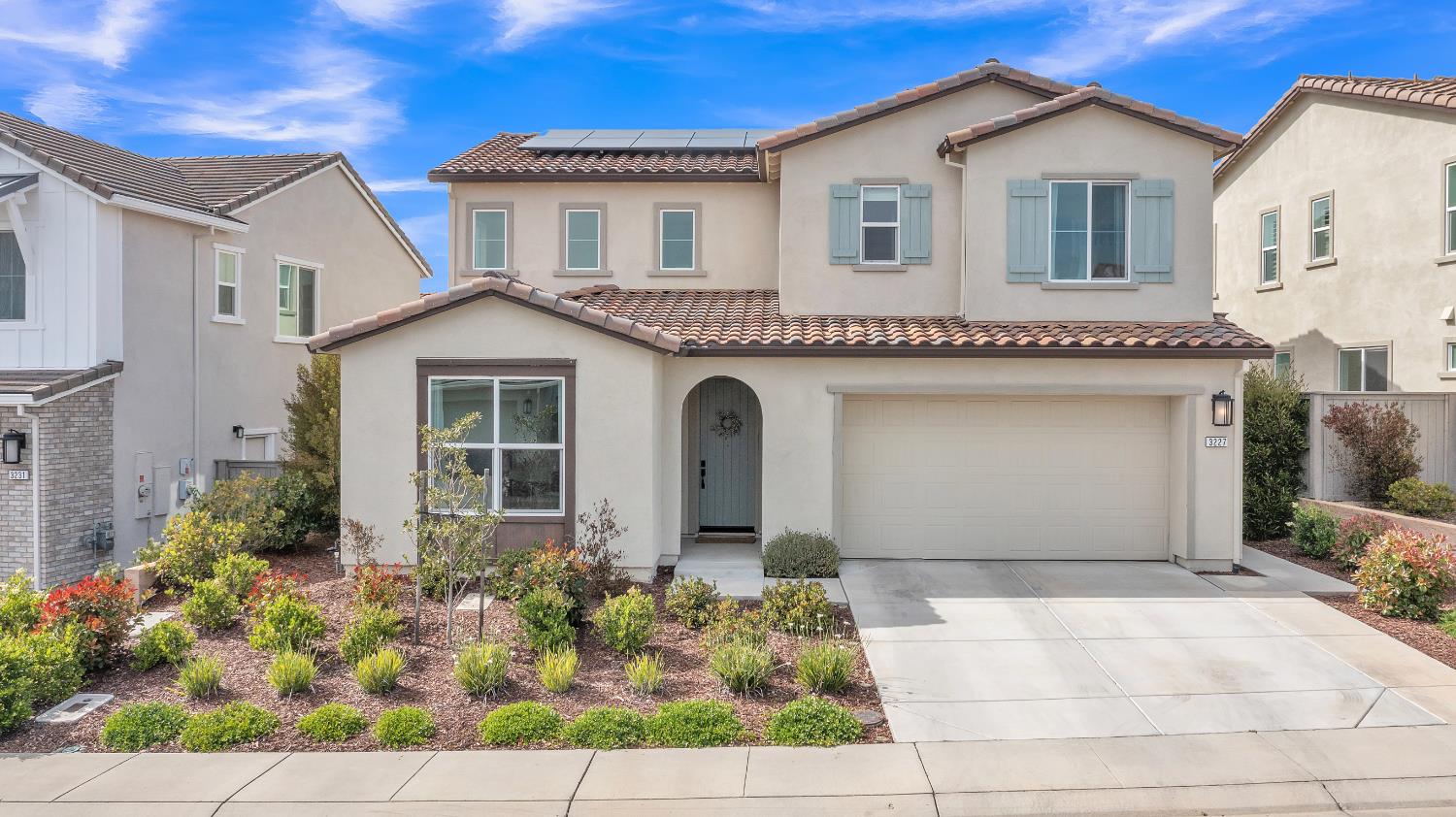 a front view of a house with garden