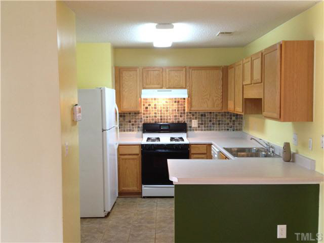 6200 Quitman Trail Raleigh, NC 27610 - Photo 6 of 10 a kitchen with a refrigerator a sink a stove and cabinets