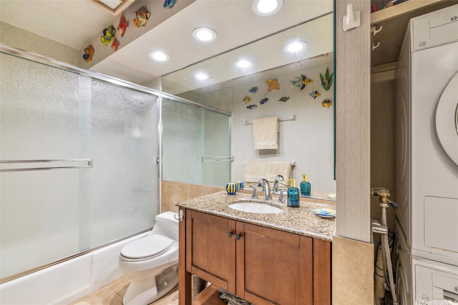 469 Ena Road, Unit 2703 Honolulu, HI 96815 - Photo 17 of 25 Guest bathroom with shower, bathtub combination. Convenient in-unit washer/dryer