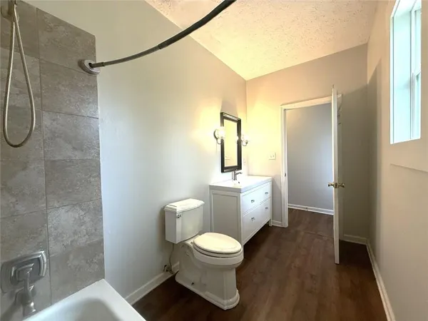 a bathroom with a toilet a sink and a shower