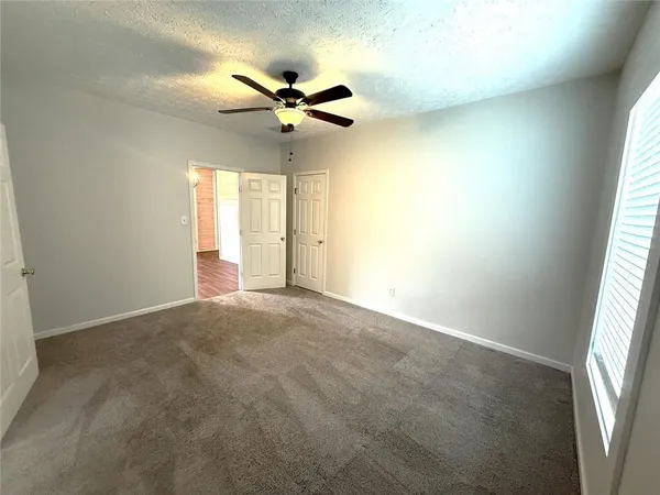 a view of a livingroom with a ceiling fan and window