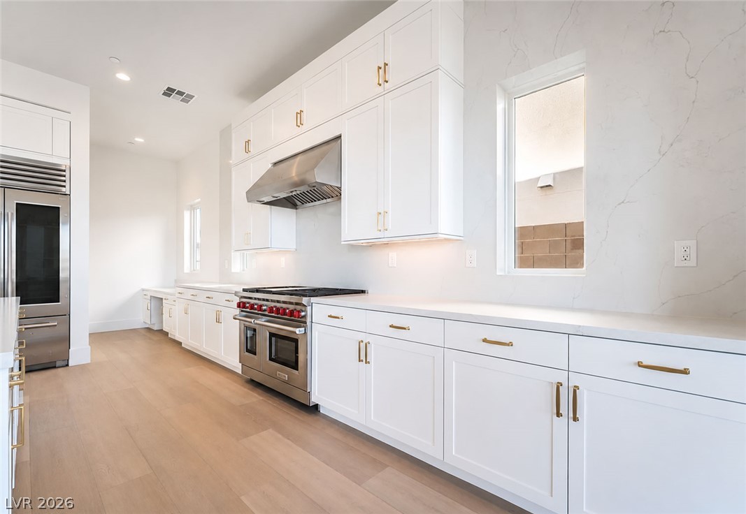 4846 Shady Rdg Drive Las Vegas, NV 89135 - Photo 6 of 60 A well-equipped kitchen features light wood flooring and extensive counter space, ideal for culinary endeavors.