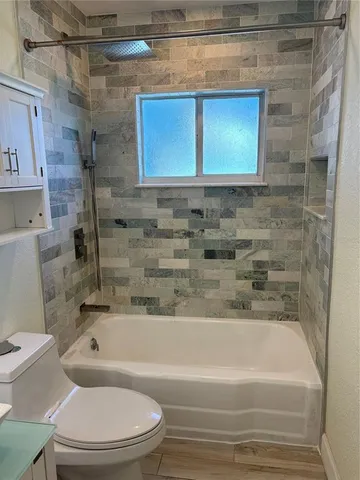 a bathroom with a toilet and bathtub