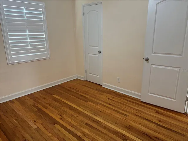 a view of a room with wooden floor and cabinet