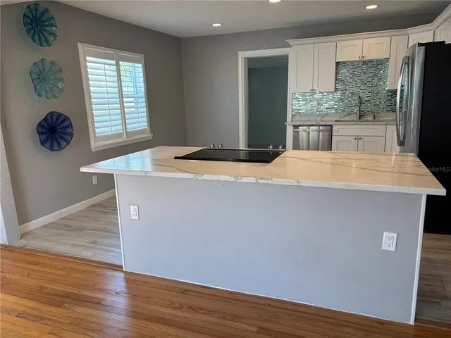 a room with wooden floor and window