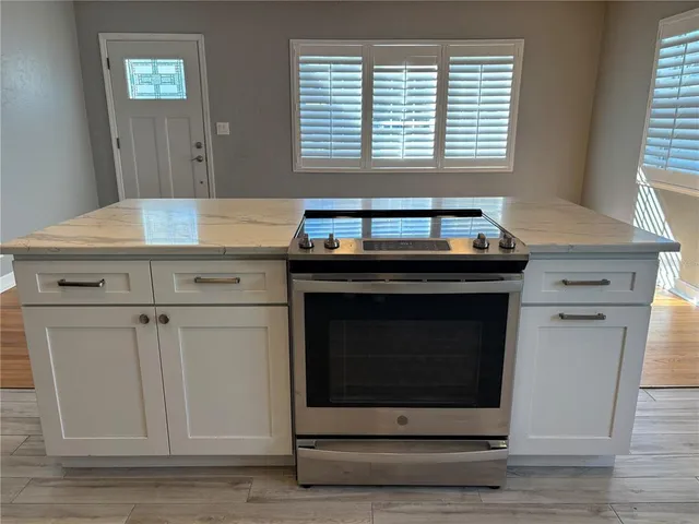 a stove top oven sitting inside of a kitchen