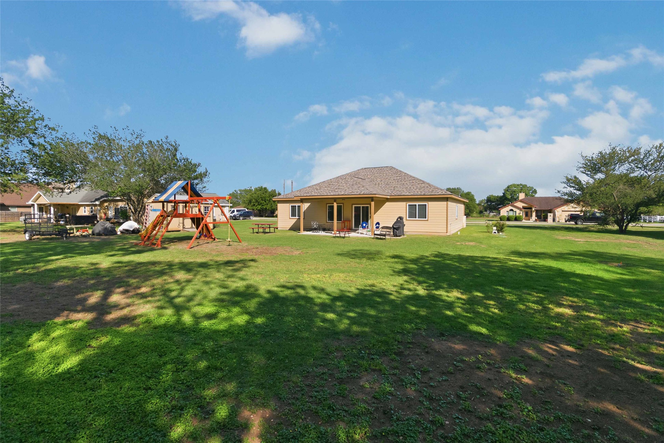 285 Hummingbird Way Martindale, TX 78655 - Photo 33 of 40 a front view of a house with garden and trees