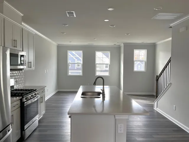 a kitchen with granite countertop a stove and a sink