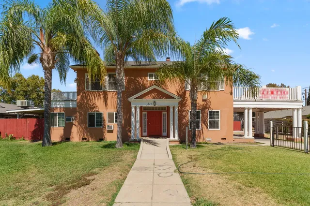 a front view of a house with garden