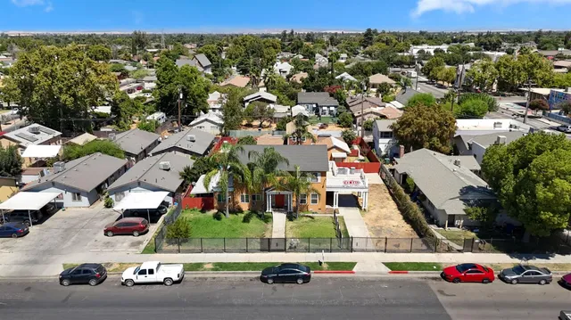 an aerial view of residential houses with street