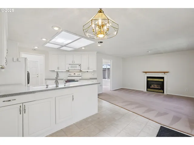 a kitchen with cabinets and chandelier