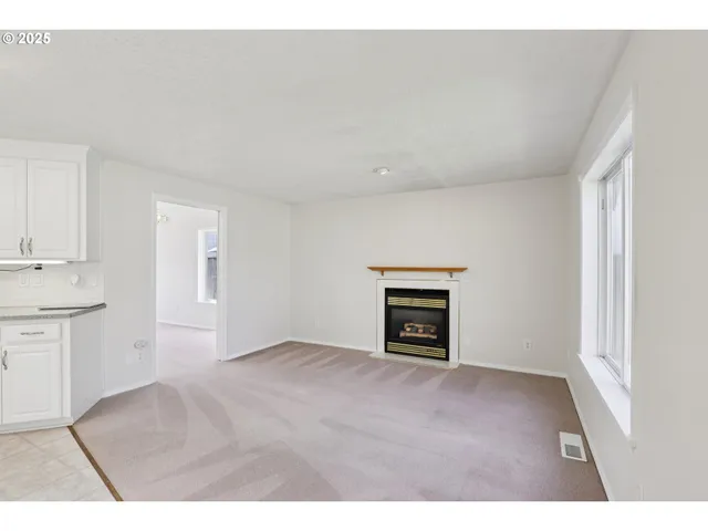 a view of empty room with a fireplace