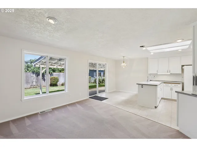 a view of a kitchen with a sink and a large window