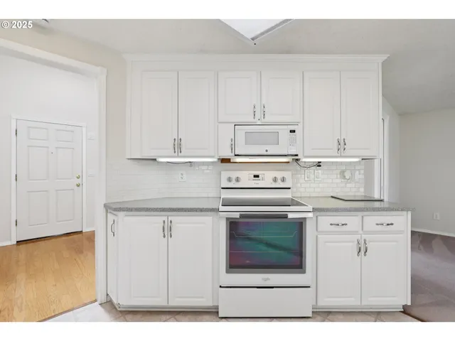 a stove top oven sitting inside of a kitchen