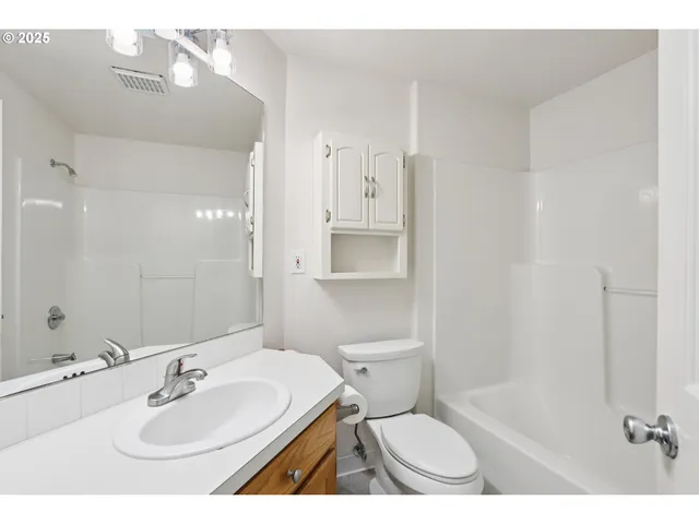 a bathroom with a sink toilet a mirror and shower